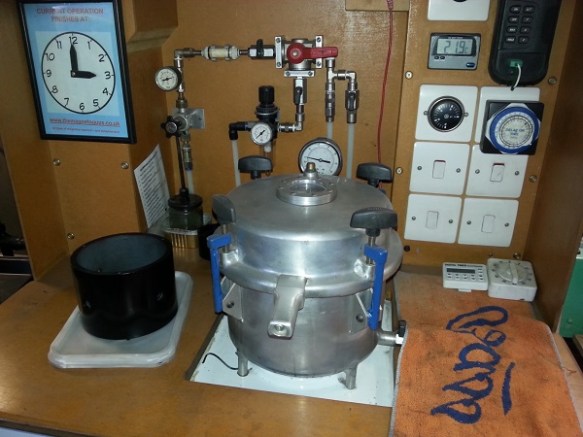 A pressure -cooker like cylinder surrounded with pieces of equipment.
