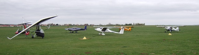 Six aircraft parked on grass.