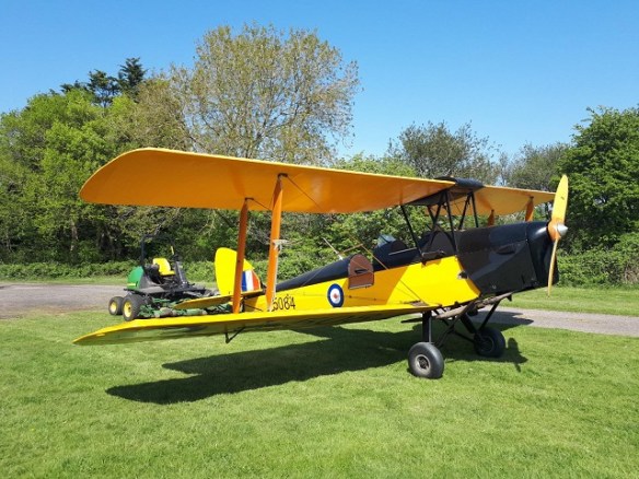 Tiger Moth attached to a small towing tractor.