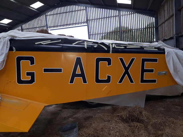 The registration letters freshly applied to the side of an aircraft.