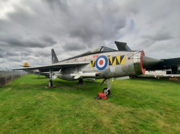 An English Electric Lightining aircraft parked on grass.